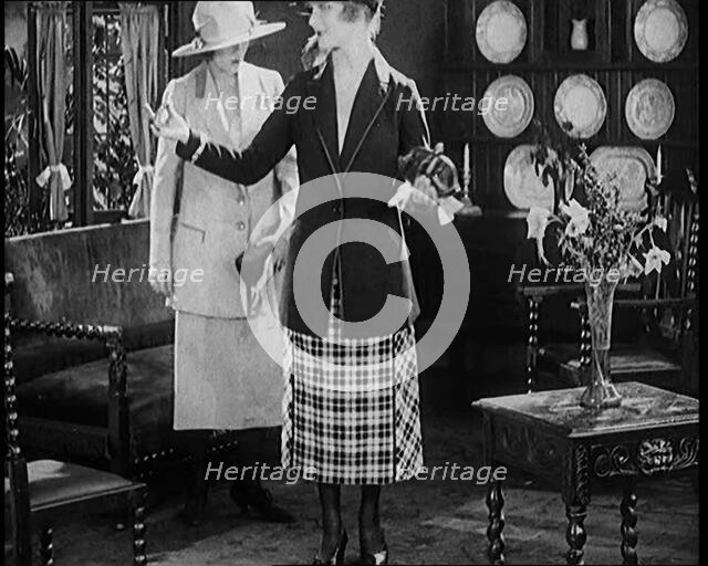 Two Female Civilians Modelling Two Piece Suits and Hats Posing in a Drawing Room, 1920. Creator: British Pathe Ltd.