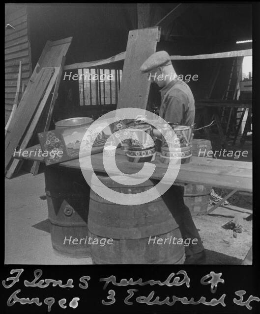 Barge painter Frank Jones, of 3 Edward Street, at work, Leighton Buzzard, Bedfordshire, 1910-60. Creator: George R Long.