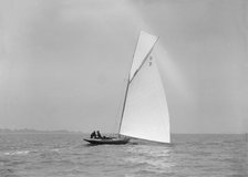 'Termagent' (H9), an early 8 Metre class yacht sails downwind, 1911. Creator: Kirk & Sons of Cowes.