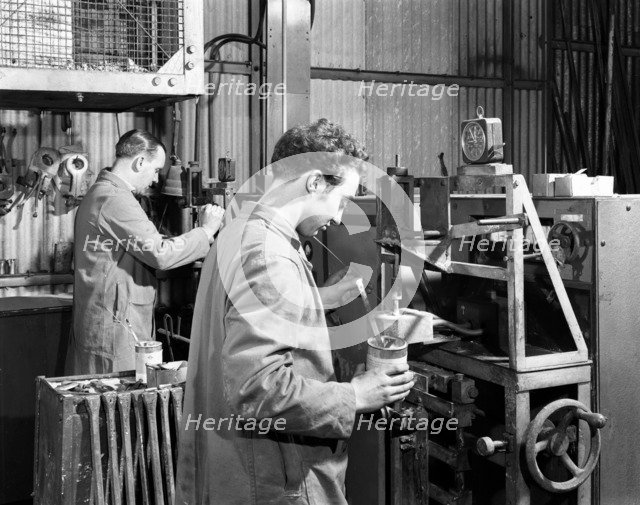 Heading at the Edgar Allen Steel Foundry, Sheffield, South Yorkshire, 1962. Artist: Michael Walters