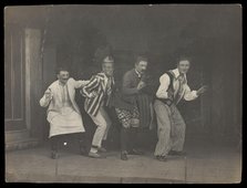 Sailors on stage in mid-pose, wearing a variety of costumes, [between 1910 and 1919?]. Creator: Unknown.