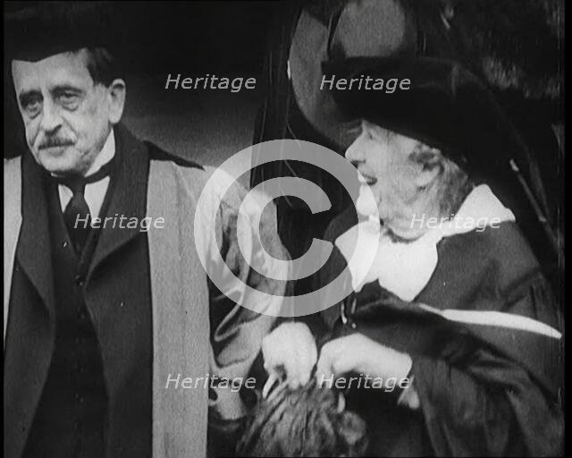 Sir James Barrie and Elen Terry Sitting Together in Academic Dress Outside St Andrew's Uni..., 1922. Creator: British Pathe Ltd.