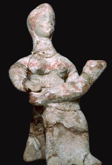 Greek terracotta statuette of a woman with a baby. Artist: Unknown