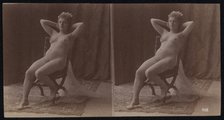 A young woman posing naked but for a long veil, leaning back in a chair, in a photographic..., c1900 Creator: Unknown.