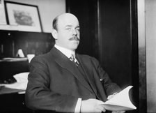 N. Longworth seated with book, 1911. Creator: Bain News Service.