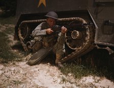 A young soldier of the armored forces holds and sights his Garand rifle..., Fort Knox, Ky, 1942. Creator: Alfred T Palmer.