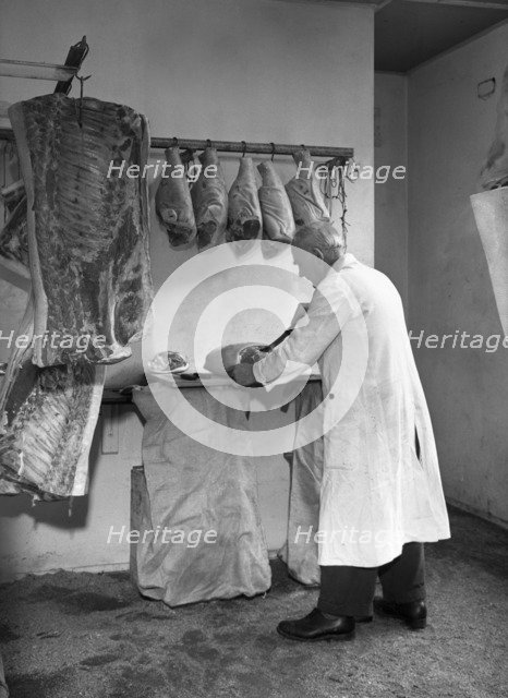 Dressing meat for sale, Rawmarsh, South Yorkshire, 1955. Artist: Michael Walters