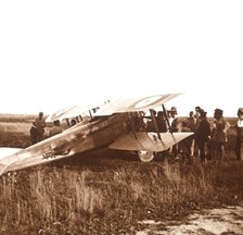 Soldiers surrounding biplane, Somme, northern France, c1914-c1918. Artist: Unknown.