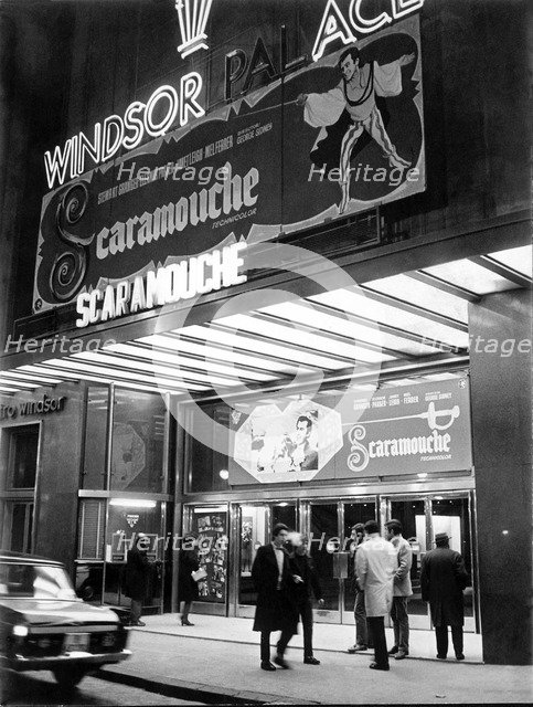 Façade of old cinema Windsor in Barcelona with neon signs advertising the film Scaromouche, 1952.