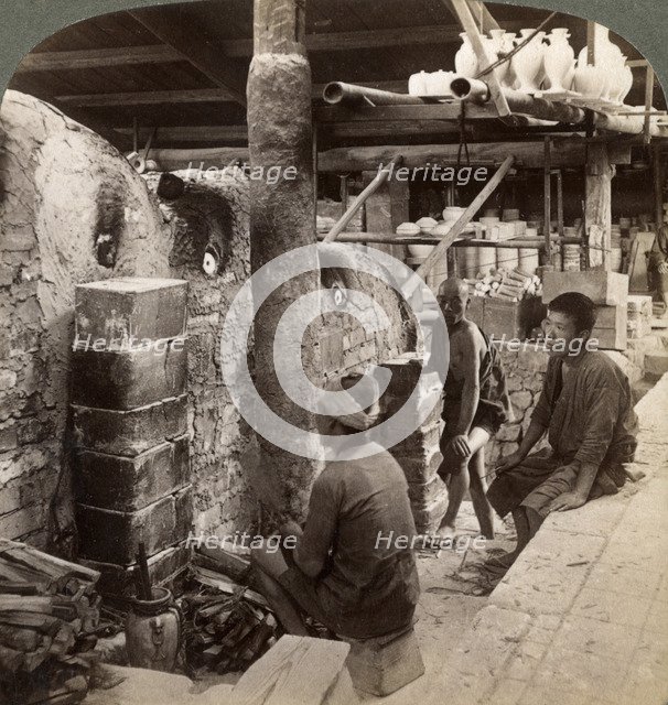 Workmen watching kilns full of Awata porcelain, Kinkosan works, Kyoto, Japan, 1904. Artist: Underwood & Underwood