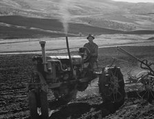 Young farmer, member of Ola self-help sawmill co-op, plowing..., Gem County, Idaho, 1939. Creator: Dorothea Lange.