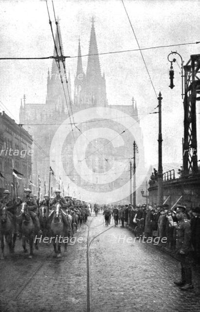 'Les Anglais sur le Rhin; A Cologne, Le defile de la cavalerie britannique a Cologne..., 1918. Creator: Jean Clair-Guyot.