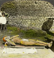 Hindu devotee on a bed of nails near the shrine of Kali, Calcutta, India, early 20th century(?). Artist: Underwood & Underwood