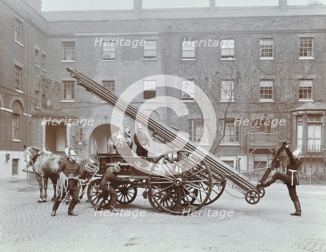 Firemen demonstrating a horse-drawm escape vehicle, London Fire Brigade Headquarters, London, 1910. Artist: Unknown.