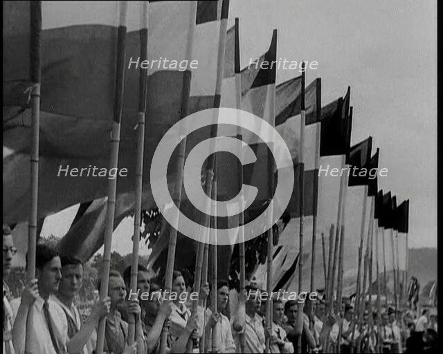 Hitler Youth Members Holding Flags, 1930s. Creator: British Pathe Ltd.
