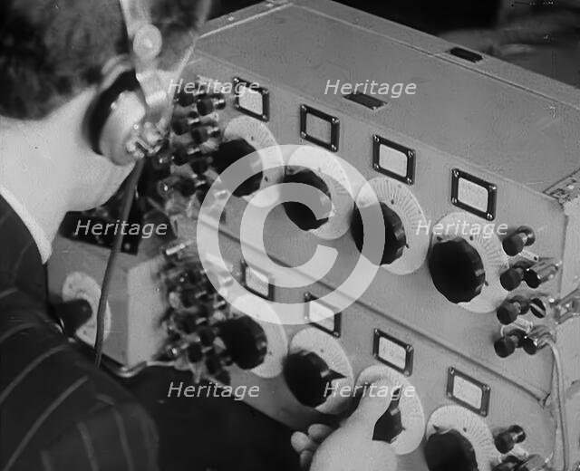 A Man Operating a Radio, 1940. Creator: British Pathe Ltd.