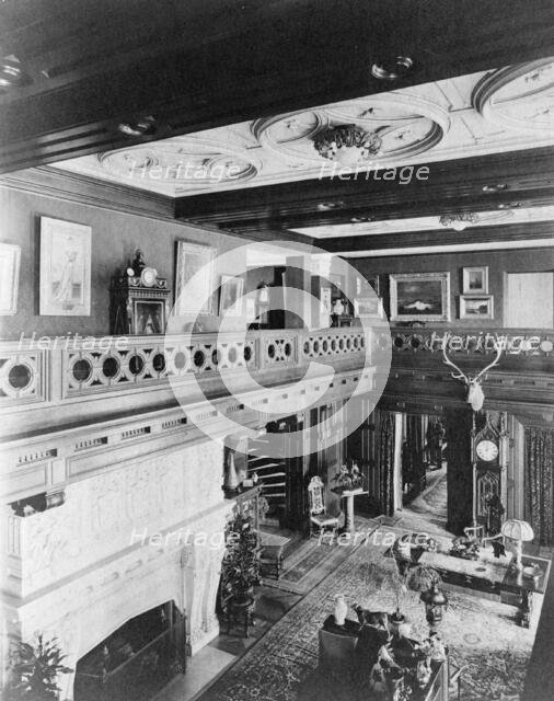 Room with balcony, paintings, fireplace, grandfather clock, and elk..., Greenwich, Connecticut, 1908 Creator: Frances Benjamin Johnston.