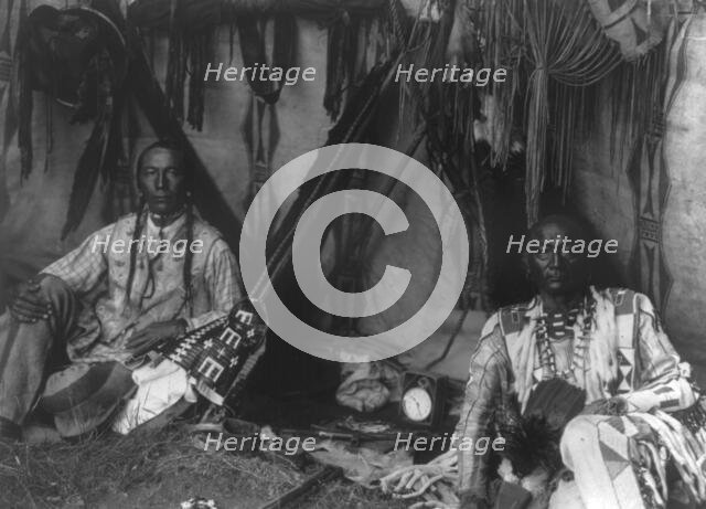 In a Piegan lodge, c1910. Creator: Edward Sheriff Curtis.