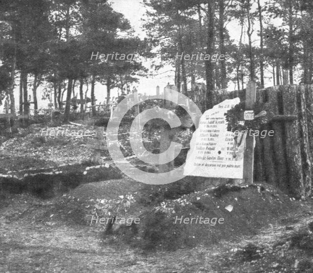 'Derriere L'ennemi refoule; Un cimetiere allemande: au premier plan, deux tombes...1915 (1924).. Creator: Unknown.
