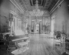 Interior view of a large hall with piano, chairs, small tables, and..., Washington, DC, c1890 - 1910 Creator: Frances Benjamin Johnston.