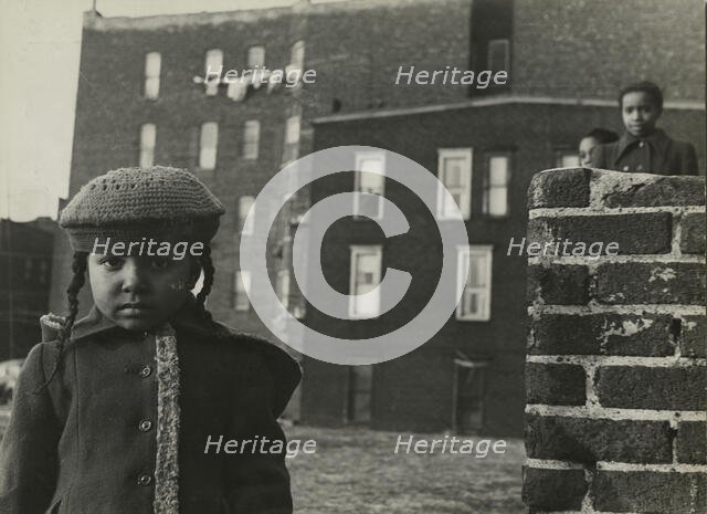 Young girl, with other children in background, in a vacant lot behind some tenement..., 1947 - 1951. Creator: Romulo Lachatanere.