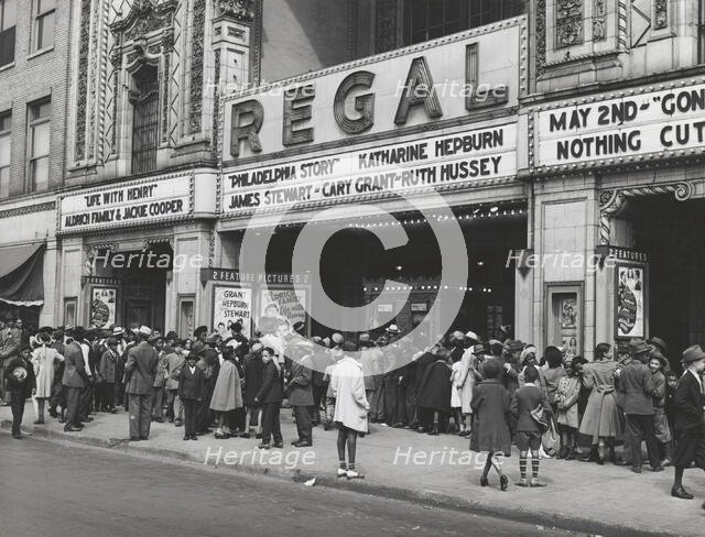 The movies are popular in the Negro section of Chicago, Illinois, April 1941. Creators: Farm Security Administration, Russell Lee.