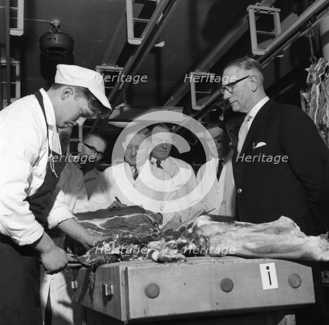 Apprentice butcher showing his work to competition judges, Barnsley, South Yorkshire, 1963. Artist: Michael Walters