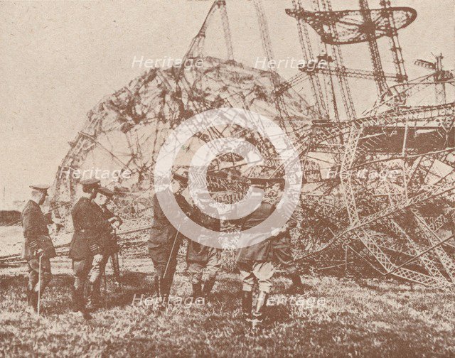British staff officers examining the wreckage of a Zeppelin brought down in England, c1917 (1919). Artist: Unknown.