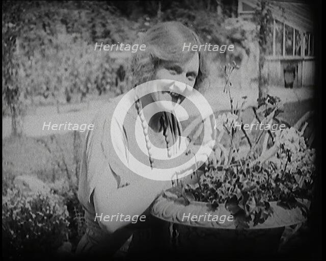 The Actress Sybil Thorndike Tending Her Flowers in a Garden, 1920s. Creator: British Pathe Ltd.