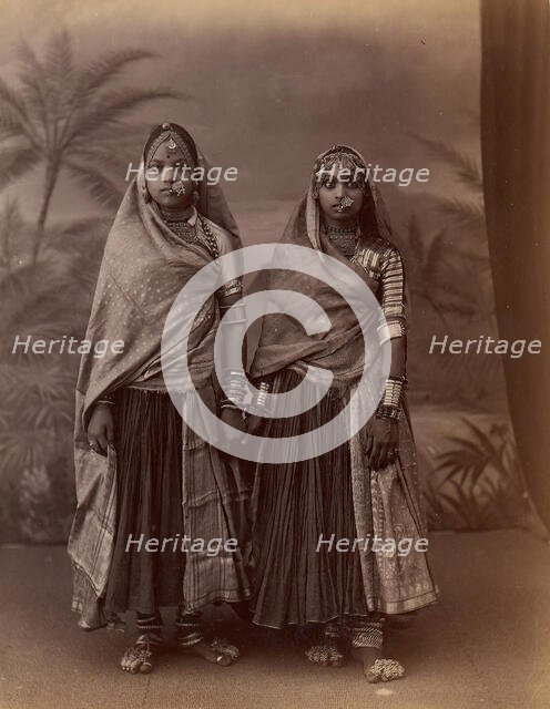 Two Hindu Women in Elaborate Jewelry, Before Studio Backdrop with Palm Trees, 1860s-70s. Creator: Unknown.