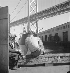 Longshoremen's lunch hour, San Francisco waterfront, California, 1937. Creator: Dorothea Lange.