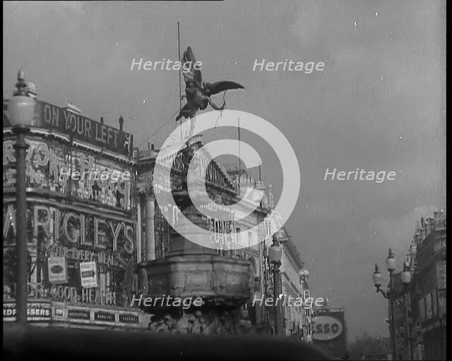The Eros Statue in Piccadilly Circus With Neon Advertising Lights on the Buildings Behind..., 1939. Creator: British Pathe Ltd.