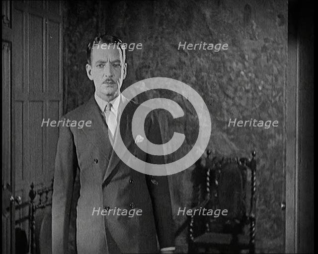 An Extract from a Silent Film. A Male Actor Enters Through a Door, 1920s. Creator: British Pathe Ltd.