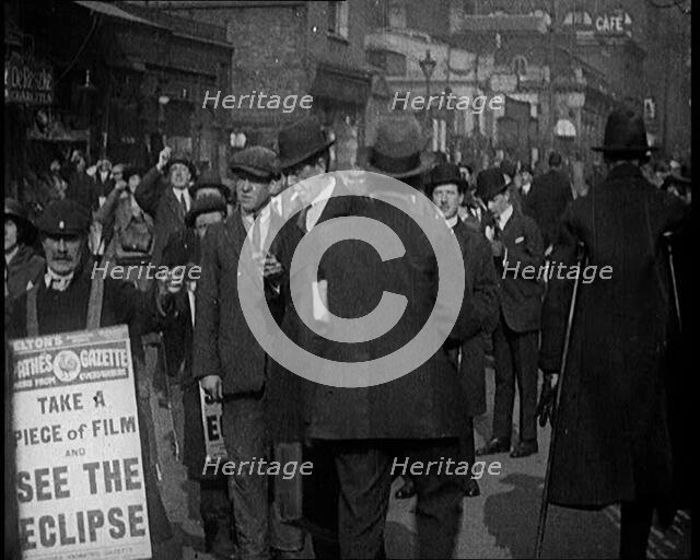 Men Wearing 'Pathe Gazette' Sandwich Boards Handing Out Pieces of Polaroid Film to Crowds..., 1921. Creator: British Pathe Ltd.