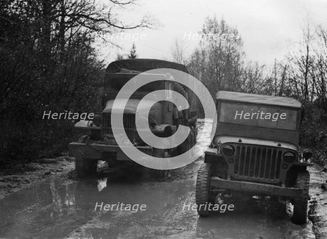 GMC 352 CCKW and Willys Jeep circa 1944. Creator: Unknown.