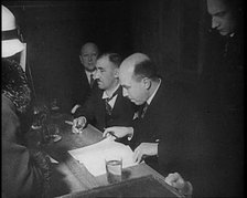 Woman Talking to Four Men Sitting at a Desk, 1933. Creator: British Pathe Ltd.