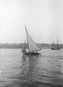 The sailing dinghy 'Hound' with flags, 1912. Creator: Kirk & Sons of Cowes.