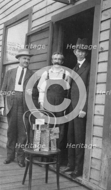 Delegate Wickersham, the assayer and Frank G. Carpenter in front of..., between c1900 and 1916. Creator: Unknown.