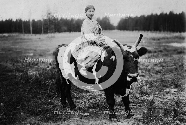 A girl riding a bull, 1890. Creator: Unknown.