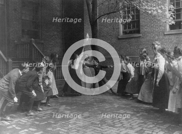Children playing game with handkerchief on stick in school yard, Washington, D.C., (1899?). Creator: Frances Benjamin Johnston.