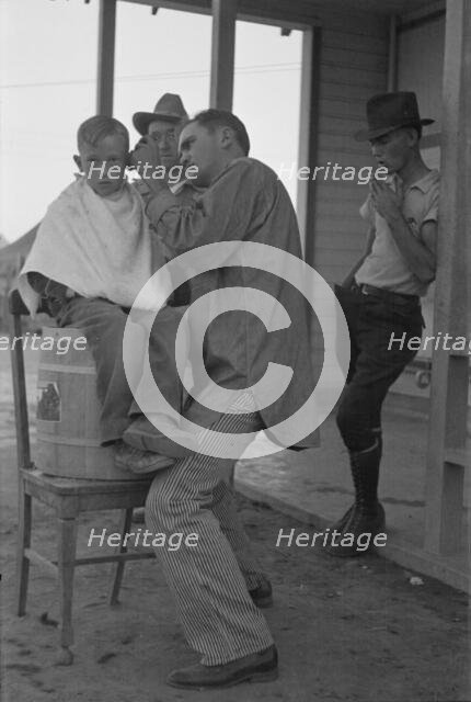 Community barber shop in Kern County migrant camp, California, 1936. Creator: Dorothea Lange.