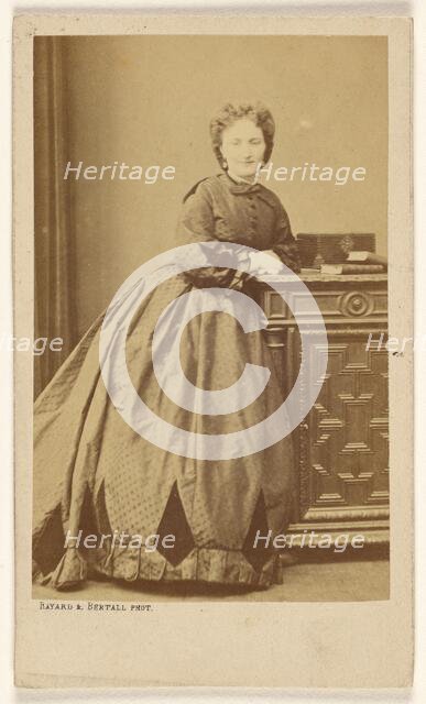 Unidentified woman standing, leaning against a credenza, about 1861. Creator: Bayard & Bertall.