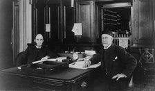 Two Treasury Department employees seated at desk in office, between 1884 and 1930. Creator: Frances Benjamin Johnston.
