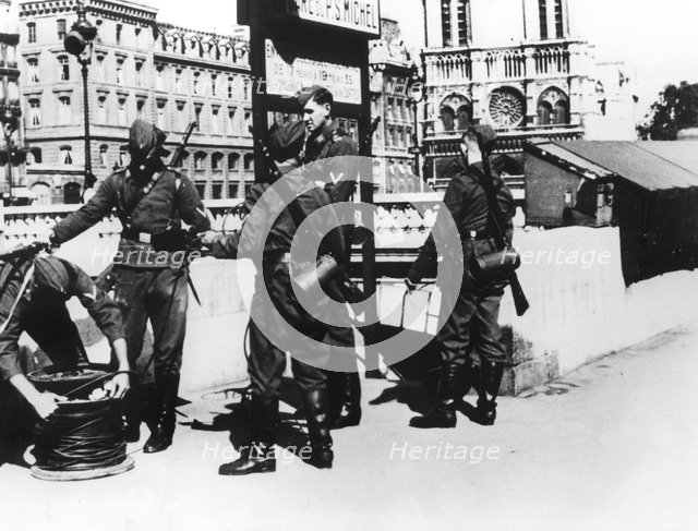 Soldiers with a telephone cable on the Pont St Michel, Paris, June 1940. Artist: Unknown