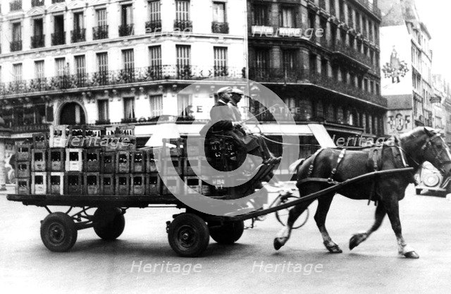 Horse-drawn cart carrying crates of drink, German-occupied Paris, July 1940. Artist: Unknown