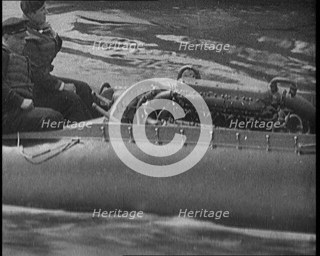Marion Barbara 'Joe' Carstairs on a Speedboat with a Male Civilian Passenger, 1920. Creator: British Pathe Ltd.