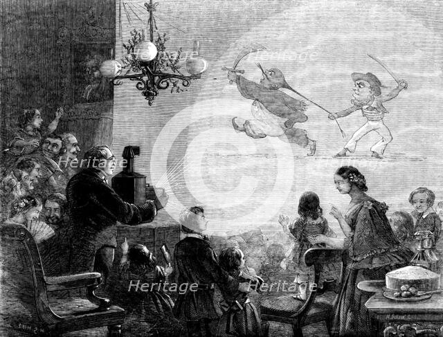 The Magic Lantern - drawn by H. G. Hine, 1858. Creator: Mason Jackson.