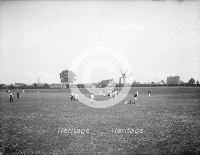 Boys playing cricket, with Thame windmill in the background, Thame, Oxfordshire, c1860-c1922. Artist: Henry Taunt