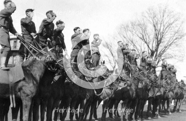 Soldiers saluting while standing on horseback, Fort Sheridan, Illinois, USA, 1920. Artist: Unknown