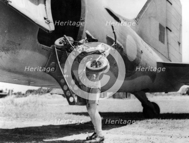 1944 Welbike being placed on to military transport plane. Creator: Unknown.